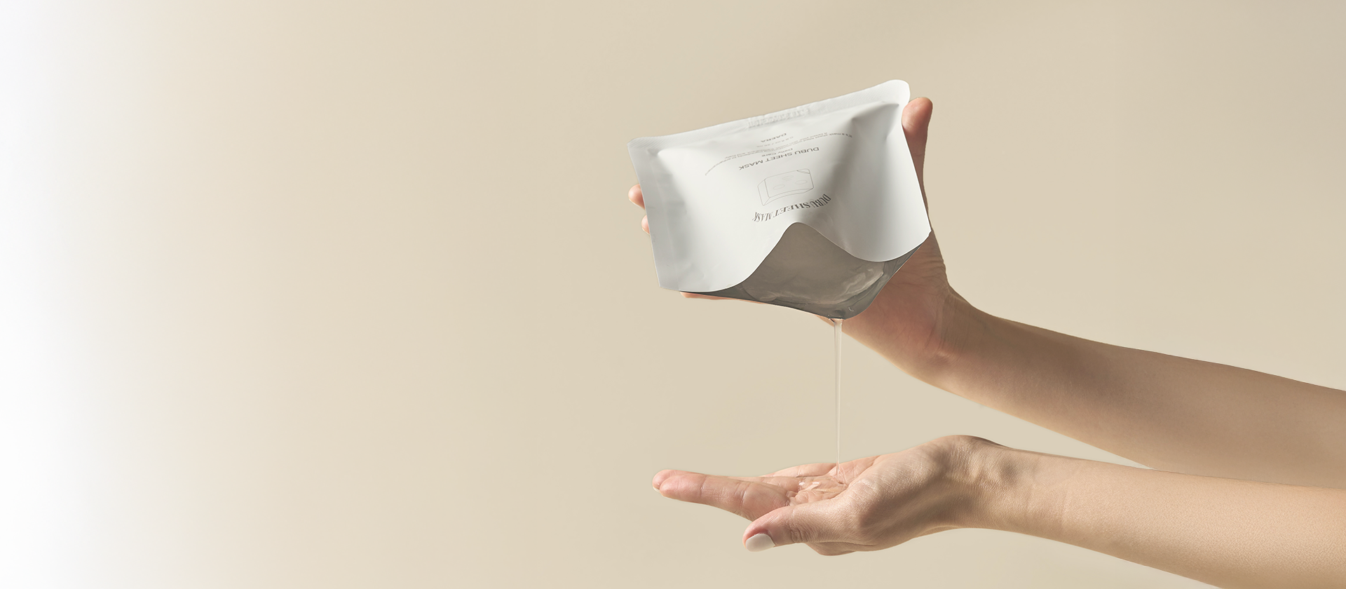 Person holding a white rectangular object with a textured surface against a beige background